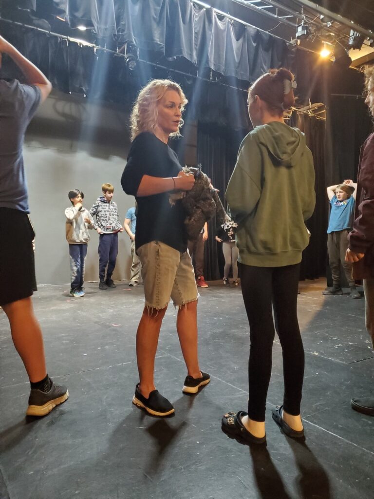 Instructor Allison Graham explaining theatre game rules